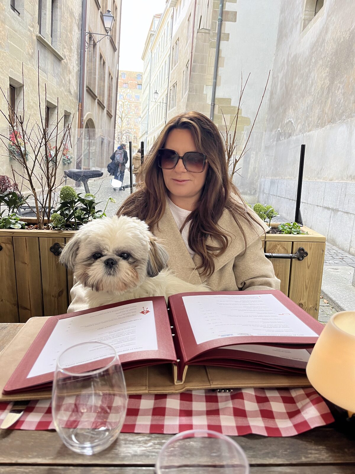 Daisy checking the menu at a restaurant terrace in Geneva