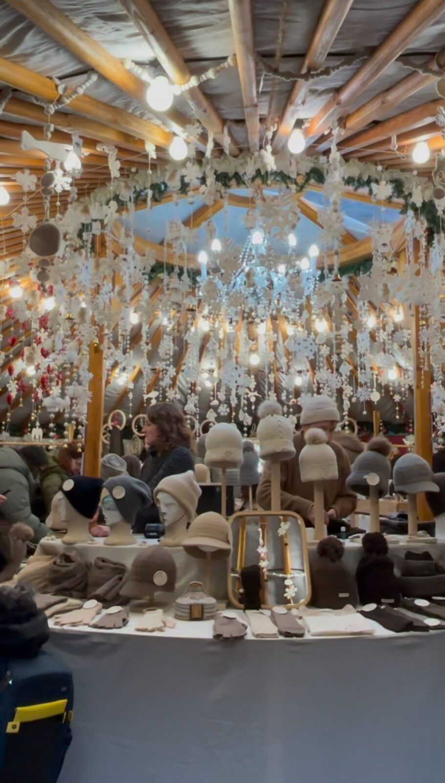 A Christmas market stall strung with snowflakes and lights