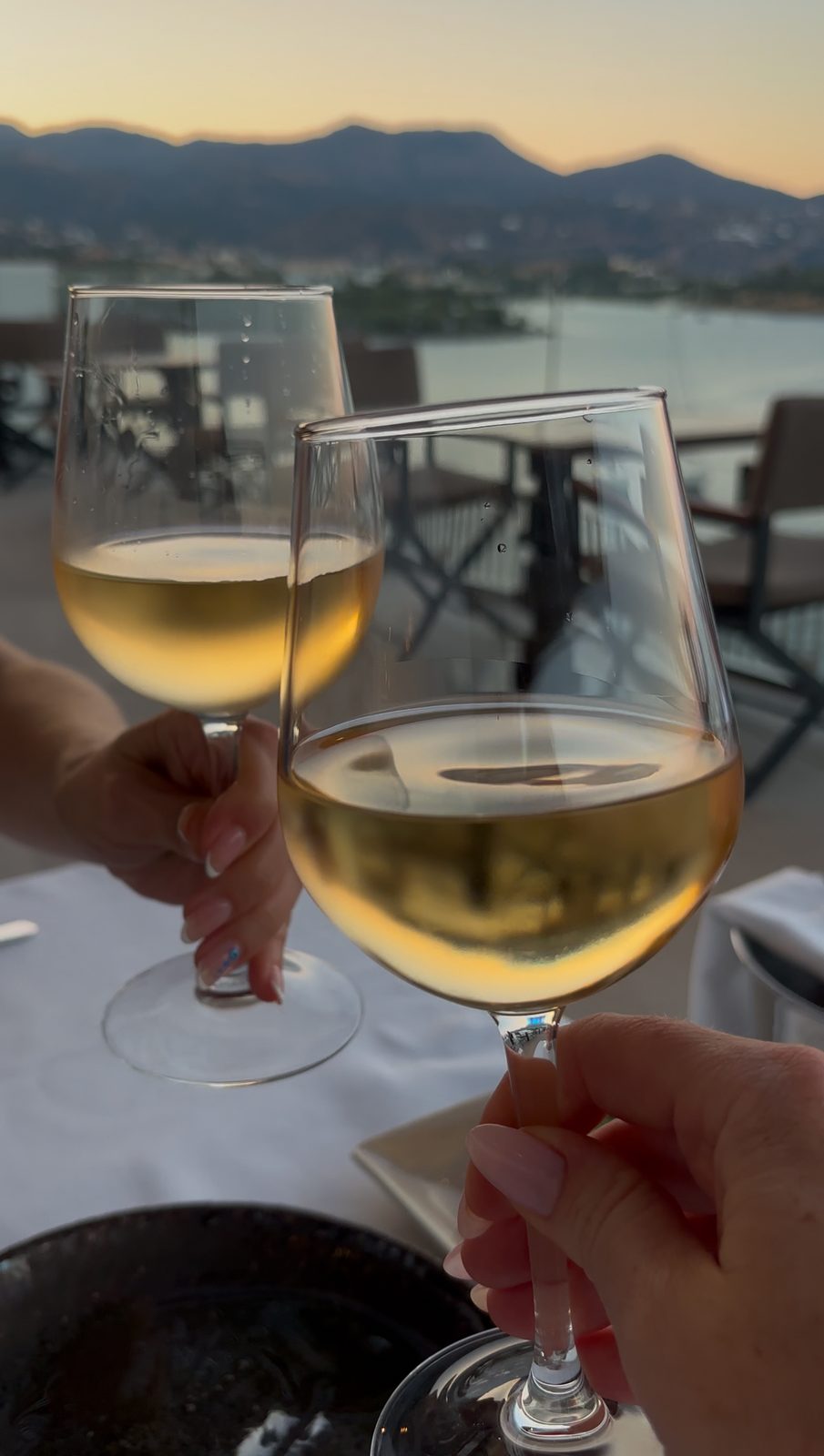 Glasses raised to Mirabello Bay, a habit we picked up at check-in and never dropped.