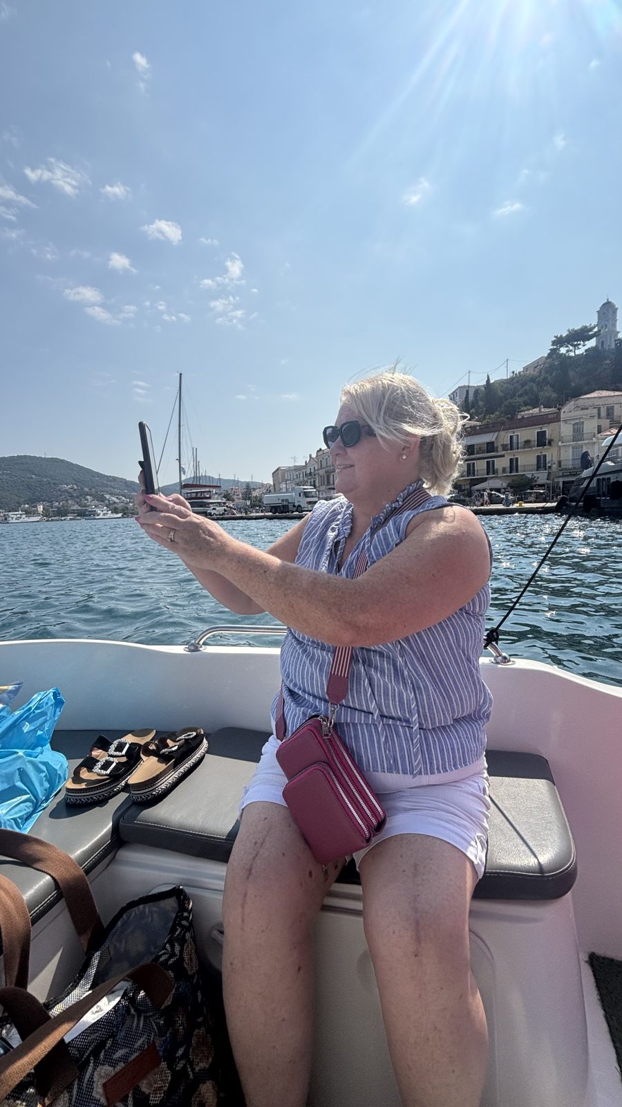 Taking photos of Poros town from a license-free rental boat