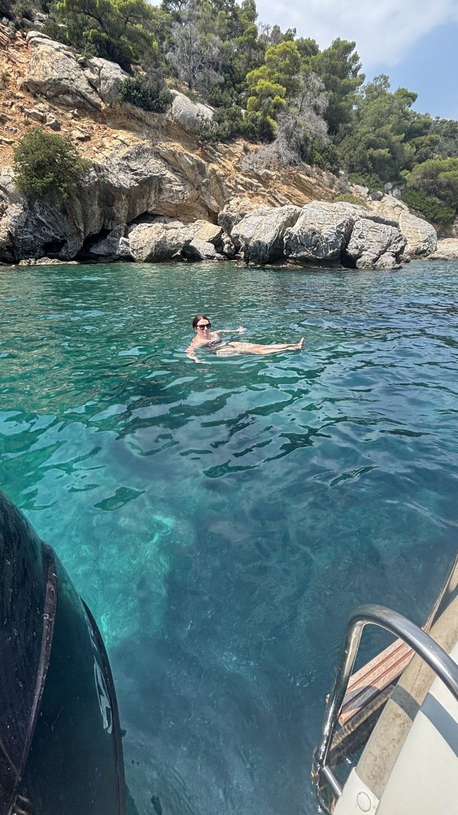 Floating in Gerolimani cove near the Poros lighthouse, the snorkeling spot the boat guys pinned for us